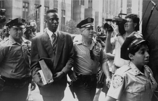Accused rapist Yusef Salaam is escorted by policein "The Central Park Five"